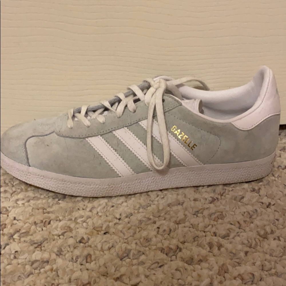 White and mint adidas gazelle shoes.